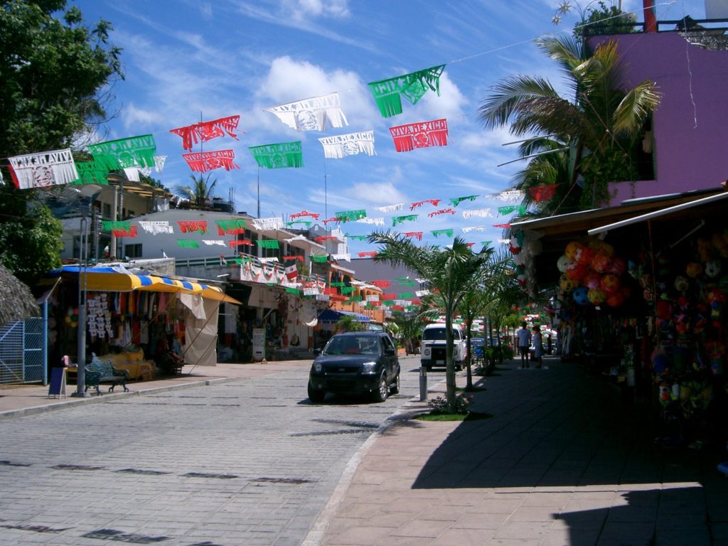 The main stretch of shops in Puerto Escondido, with the beach behind it.